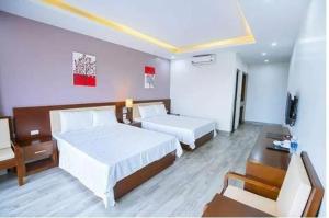 岑山的住宿－Sen Biển Hotel FLC Sầm Sơn，酒店客房配有两张床和一张书桌