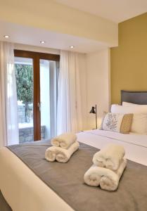 two towels are sitting on top of two beds at NiMar Villa in Sitia