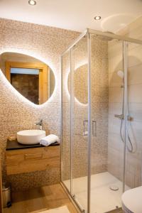 a bathroom with a sink and a shower at Chalet Holtanna Mountain Voyages in Montriond
