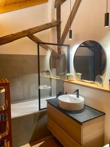 a bathroom with a sink and a bath tub at Chalet Fr Gilkens Arc 1600 in Bourg-Saint-Maurice