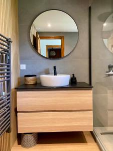 a bathroom with a sink and a mirror at Chalet Fr Gilkens Arc 1600 in Bourg-Saint-Maurice