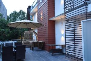 a patio with a table and an umbrella at Hotel Dreams Connect GRB 2 in Kathmandu