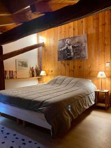 a bedroom with a bed in a wooden wall at Chalet Fr Gilkens Arc 1600 in Bourg-Saint-Maurice