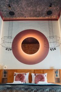 a bedroom with a bed with a large circle on the wall at Cu Residence - LoftAffair Collection in Krakow