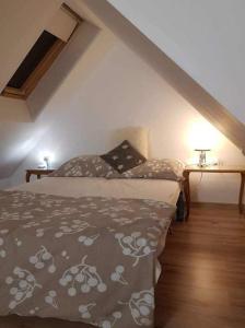 a bedroom with a bed and two tables with lamps at Zajazd Ponikiew - Noclegi Wadowice in Wadowice