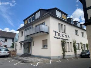 a white building with a sign on the side of it at Ferienwohnung Trenz in Geisenheim