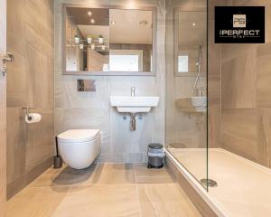 a bathroom with a toilet and a sink and a shower at The Lexington - Luxury Serviced Apartments City Centre - City and Waterfront views in Liverpool +32 photos