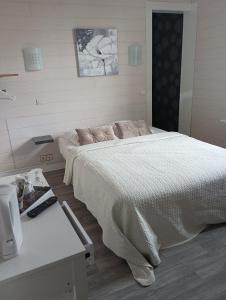 a bedroom with a large bed and a table at Hotel de la Gare in Noyers-sur-Cher