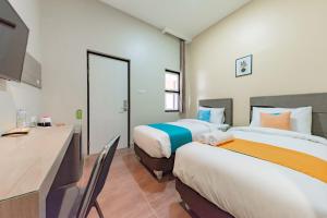 Postel nebo postele na pokoji v ubytování Sans Hotel Berau Square + 37 fotografií