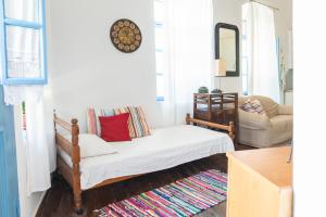 a living room with a couch and a chair at Imerios Nisyrian House in Mandrákion