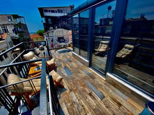 a balcony with a wooden table and chairs on a ship at GOLDEN ARROW OLD CİTY HOTEL in Istanbul