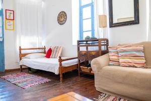 a living room with a couch and a chair at Imerios Nisyrian House in Mandrákion +34 photos