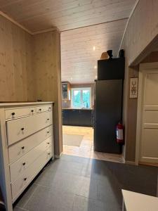 a kitchen with a black refrigerator in a room at Hytte med flott utsikt in Beitostøl