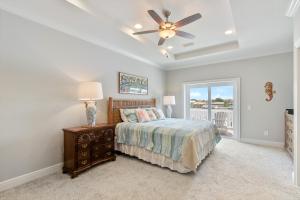 a bedroom with a bed and a ceiling fan at Banana Bay 13912 By Pkrm in Pensacola +55 photos