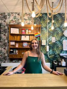 a woman standing at a counter in a store at Hostelle - women only hostel London in London