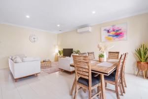 a living room with a wooden table and chairs at 4 bedrooms house walking to shopping town#20A in Doncaster