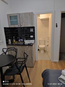 a kitchen with a table and chairs and a bathroom at Nahal Oz 33 in Tel Aviv