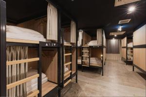 grupa łóżek piętrowych w pokoju w obiekcie Mash Cafe & Bed NAGANO w mieście Nagano