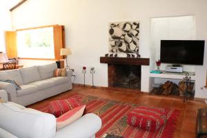 a living room with a white couch and a fireplace at Monte da Casa Nova - Jul and Ago only 7 days stays check-in and check-out on Saturdays in Vale de Água