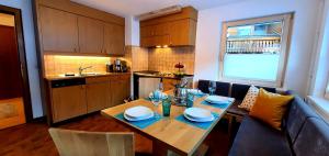 a kitchen with a dining table and a kitchen with a kitchen at Chasa Max in Samnaun