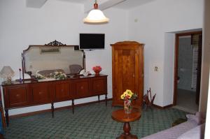 a living room with a dresser and a mirror at Casa Millefiori in Bagni di Lucca