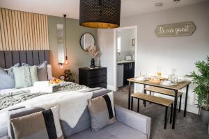 a bedroom with a bed and a table and a kitchen at Blackpool Abode - Coastel Suite Apartment in Blackpool