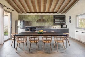 a kitchen with a dining room table and chairs at Terreforti Luxury Village in Agrigento