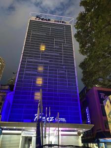 a tall blue building with a fedex sign on it at Frenz Hotel Kuala Lumpur in Kuala Lumpur