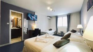 a hotel room with a large bed and a bathroom at Auberge de la Petite Reine in Siorac-en-Périgord +30 photos