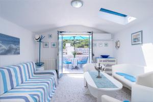 a living room with a couch and a table at Apartments Villa Domus Marini in Hvar