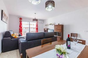 a living room with a couch and a table at Apartamento Azucarera Beach Torre del Mar in Torre del Mar
