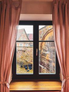 a window with a view of a building at Storchenhof Teningen in Teningen