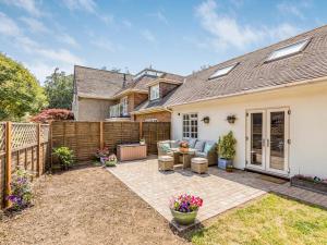 a home with a patio and a fence at Pass the Keys Charming Cottage with Garden in Chichester