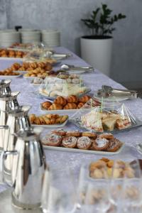 a table topped with lots of different types of pastries at Mir Luxe Plaza in Tashkent
