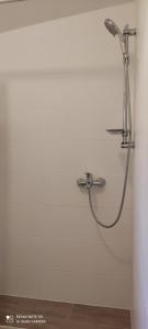 a shower in a white wall with a hose at Apartments Sandra in Vrsar +40 photos