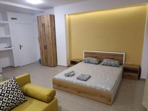 a bedroom with a bed and a couch at Kilkis Central Studio 2 in Kilkís