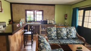 a living room with a couch and a kitchen at Lianita's Cottage (Selfcatering) in La Digue