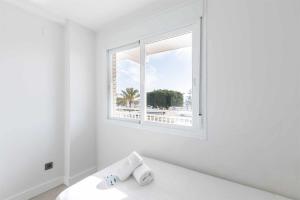biały pokój z oknem i łóżkiem w obiekcie A&N Seafront Torre del Mar w mieście Torre del Mar