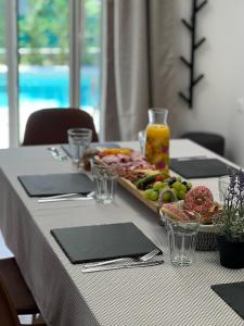 a table with a tray of food on it at Luxury Kvarner Park Villa with garden and large RGB private pool in Kastav