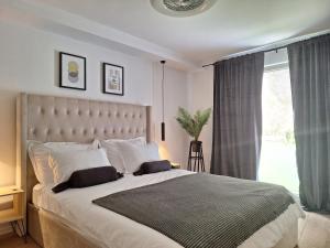 a bedroom with a large bed with a large window at Luxury Kvarner Park Villa with garden and large RGB private pool in Kastav +68 photos