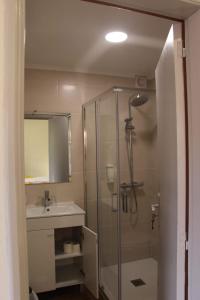 a bathroom with a shower and a sink at Casa da Tia Clementina in Santana