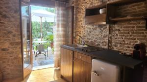 a kitchen with a sink and a counter top at The Cellar Studios - by Avelink in Spata