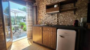 a kitchen with a sink and a refrigerator at The Cellar Studios - by Avelink in Spáta
