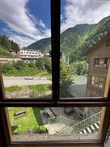 an open window with a view of a mountain at Abduloğlu Butik Otel in Ayder Yaylasi
