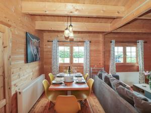 a living room with a table and a couch at Pigsfoot Lodge in Tiverton