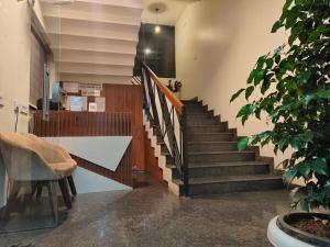 a staircase in a building with a potted plant at Royalton Residency in Mundakāyam