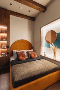 Schlafzimmer mit einem Bett mit einem Kopfteil aus Holz in der Unterkunft Cu Residence - LoftAffair Collection in Krakau