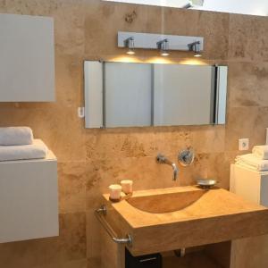 a bathroom with a wooden sink and a mirror at Chambres d'Hôtes Bianca Casa in Porto-Vecchio