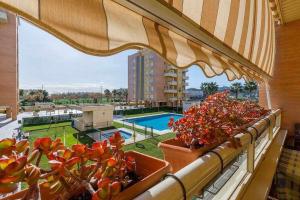 a balcony with a view of a pool and some plants at A&N La Vega 2 in Torre del Mar