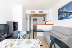 a living room with a couch and a table at A&N Seaport 1B in Caleta De Velez